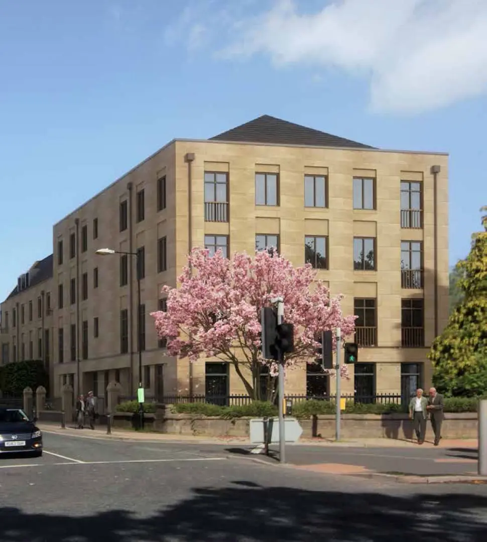 Southfield & Ellis House, a four-storey stone apartment building on Station Parade, Harrogate, with a magnolia in bloom