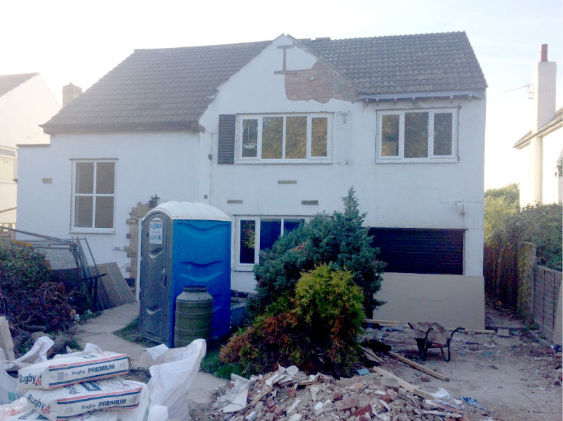 Barnsley Road house during renovation with rubble and a site toilet outside